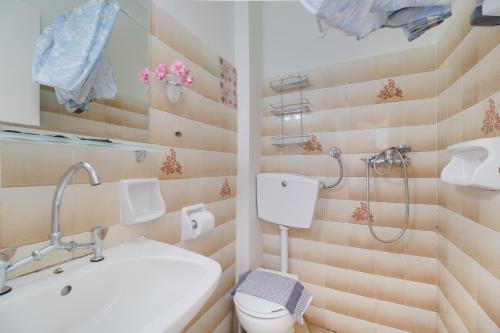 a bathroom with a sink and a toilet and a shower at S7 apartment in Nikiana