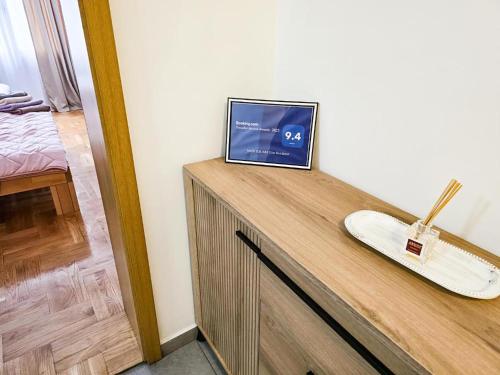 a television sitting on top of a wooden counter at Seven Tower FREE PARKING in Skopje
