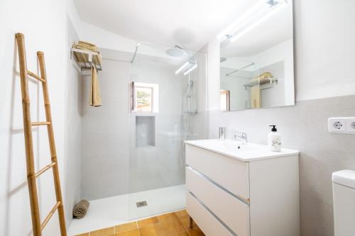 a bathroom with a shower and a white sink at Ca'n Repic in Port de Soller