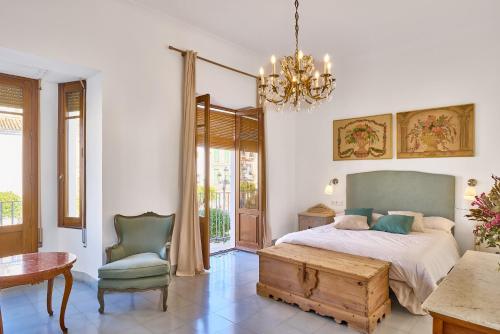 a bedroom with a bed and a table and a chair at Vtar Casa Palacio Vida in Espejo