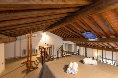 a attic room with a bed and a table at Borgo San Carlo in Santa Luce