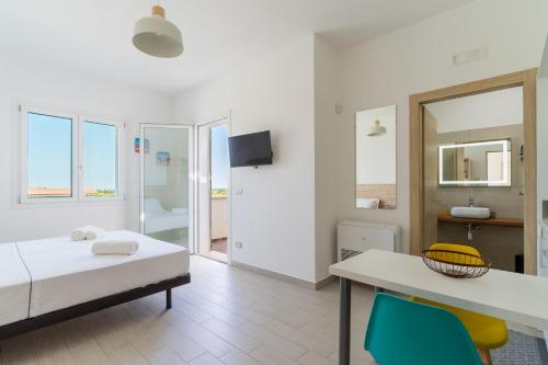 a bedroom with a bed and a table and chairs at Le scuderie 9 in Galatone