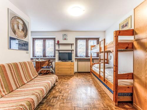 a living room with a couch and bunk beds at Apartment Richardette by Interhome in Sauze d'Oulx