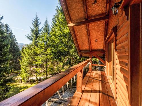 a balcony of a cabin with a view of trees at Chalet Hidden Heaven by Interhome in Sunger