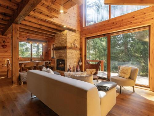 a living room with a fireplace in a log cabin at Chalet Hidden Heaven by Interhome in Sunger