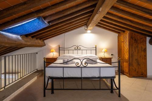 a bedroom with a large bed in a room with wooden ceilings at Borgo San Carlo in Santa Luce