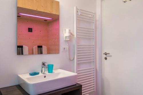 a bathroom with a white sink and a mirror at Apartment Cater Residence Bun Ste in San Vigilio Di Marebbe
