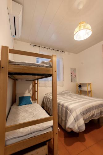 a bedroom with two bunk beds and a chandelier at Villa natura 20 km de las playas in Sils