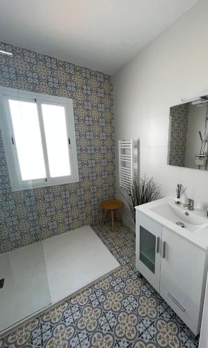 a bathroom with a sink and a toilet and a mirror at Salida Del Sol in Nerja