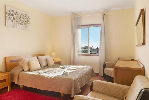 a bedroom with a bed and a window at Oliveira Atlantic View in Funchal