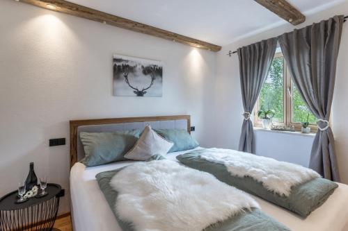 a bedroom with a bed with two pillows at Fewo beim Nik mit Wanderreitstation in Höslwang