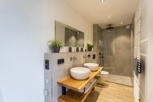 a bathroom with two sinks and a shower at Fewo beim Nik mit Wanderreitstation in Höslwang