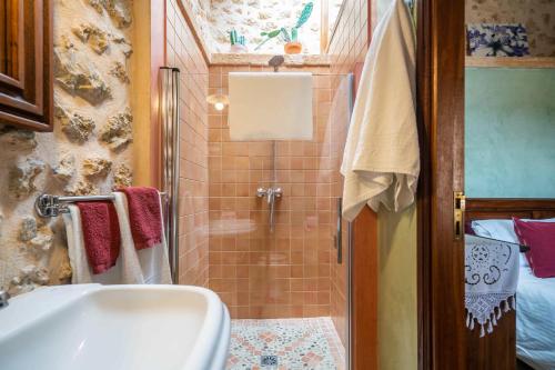 a bathroom with a shower and a sink at Can Pulit in El Port de la Selva