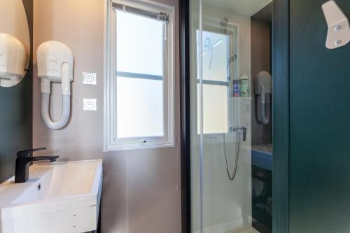 a bathroom with a sink and a shower at Camping Lou Soulei 218 in Carry-le-Rouet
