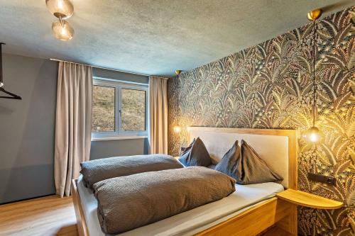 a bedroom with a bed with a gold patterned wall at Luisalle Top 5 in Auffach