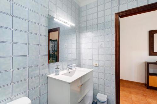 a bathroom with a white sink and a mirror at Casa Laly in Callao Salvaje