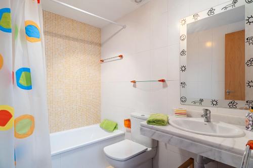 a bathroom with a sink and a toilet and a tub at Casa Alena in Conil de la Frontera