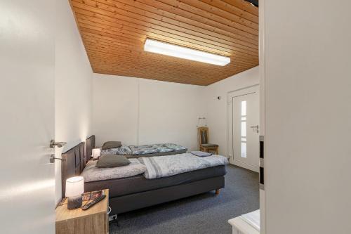 a bedroom with two beds and a wooden ceiling at 2 Bett Apartment a d A8 - W5 in Beckingen