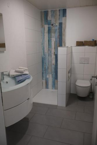 a white bathroom with a toilet and a shower at Ferienwohnung Spielmann in Sauldorf