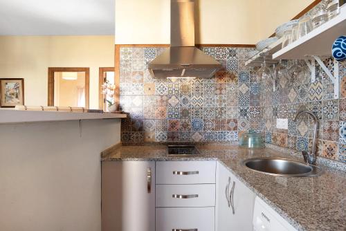 a kitchen with a sink and a counter top at Casa Dorca 1 in Conil de la Frontera