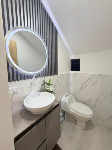 a bathroom with a sink and a mirror at Vive Manta como nunca antes! in Manta