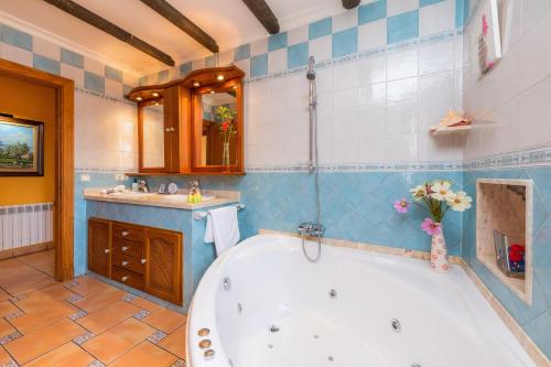 a bathroom with a tub and a sink at Can Lopez Vara in Campos