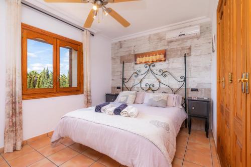 a bedroom with a bed and a window at Can Lopez Vara in Campos