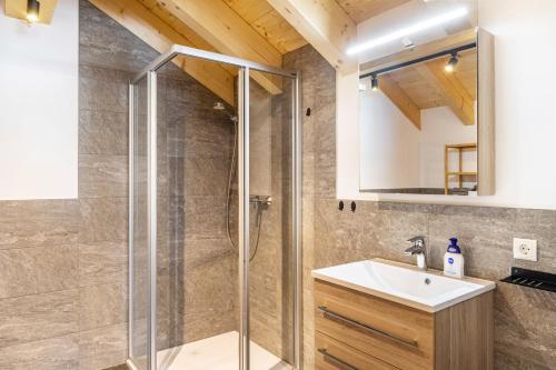 a bathroom with a shower and a sink at Apartment Alte Mühle in Scharnitz