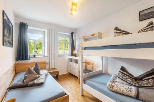 a bedroom with two bunk beds and a couch at Ferienhaus Enztal in Zweifelscheid