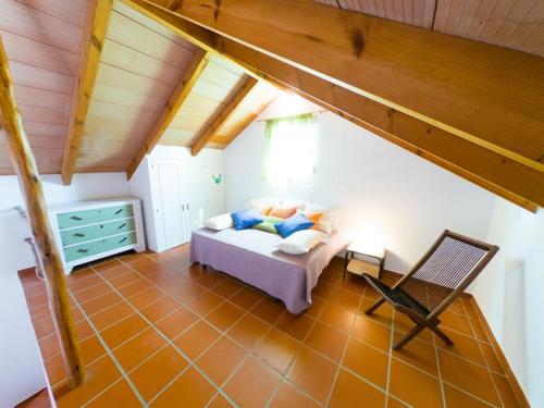 a bedroom with a bed and a chair in a room at Casas Pepe 6 Bungalow in Los Caños de Meca