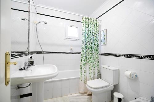 a bathroom with a sink and a toilet and a shower at Chalet Cormoran in Chiclana de la Frontera