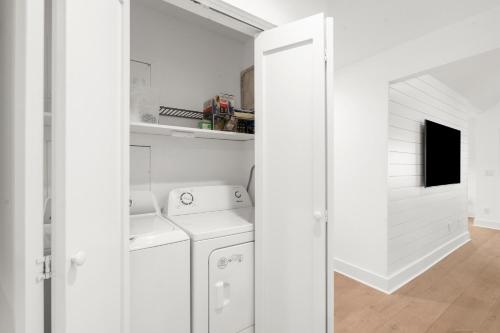 a white laundry room with a washer and dryer at 4826 Green Dolphin Way in Kiawah Island