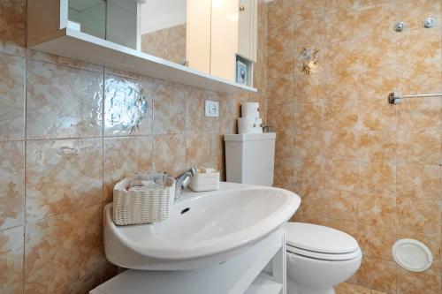 a bathroom with a sink and a toilet at Ciclamino Standard Vittoria in San Lorenzo in Banale