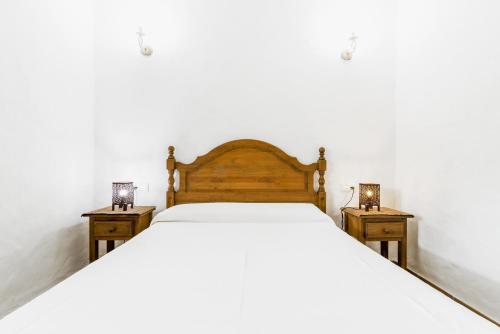 a bedroom with a large bed with two night stands at El Madroño in El Palmar