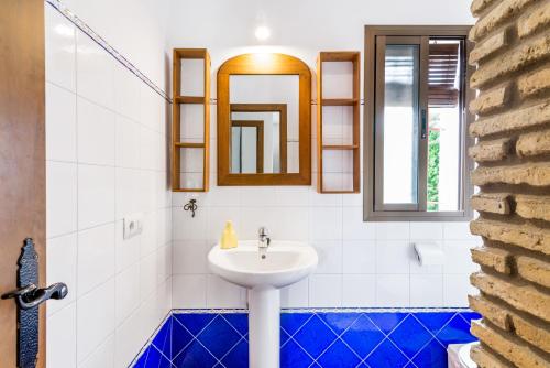 a bathroom with a sink and a mirror at El Madroño in El Palmar
