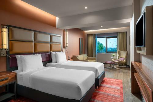 a hotel room with two beds and a television at Sile Gonen Hotel in Şile