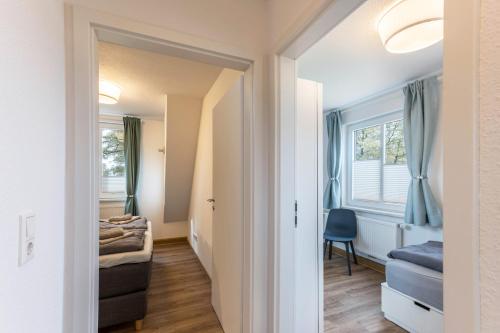a small room with a bed and a window at Haus Hein Mück in Norden