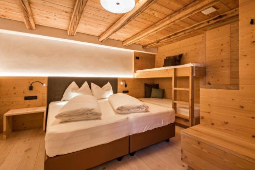 a bedroom with a bed and bunk beds at Hatzeshof Blumenwiese in Laion
