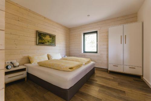 a bedroom with a large bed and a cabinet at Blockhaus 2 in Eslohe