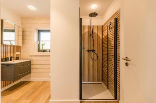 a bathroom with a shower with a glass door at Blockhaus 2 in Eslohe