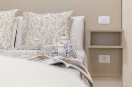 a bed with a book and a tea set on it at Puerto Playa 3 in Puerto del Rosario
