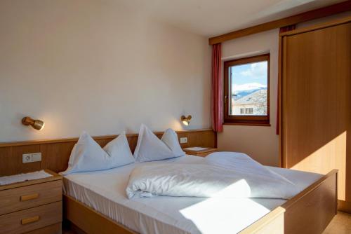 a bedroom with a large bed with a window at Apartment 4 - Zur Sonne in Laion