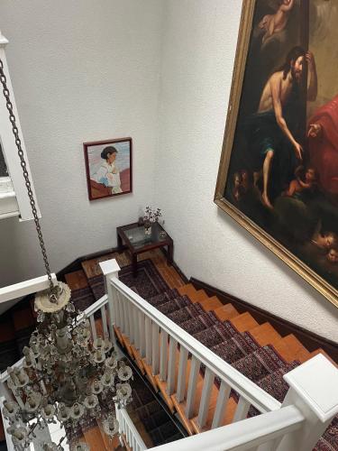 a stairway with a painting on the wall at Anys Hostal in Mexico City