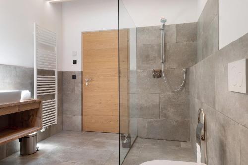 a bathroom with a shower with a toilet and a sink at Living Lerchna - Schöne Aussicht 2 in Maranza