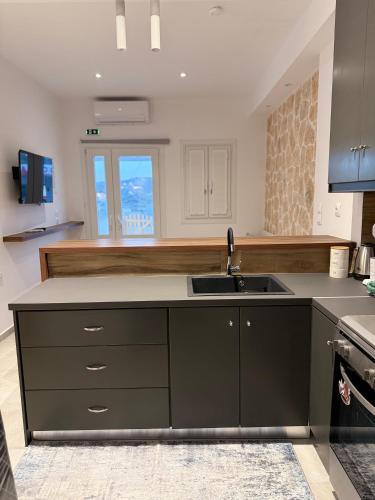 a kitchen with a sink and a counter top at Kamara Studios in Alinda