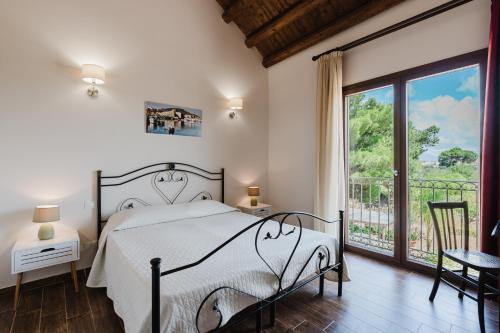 a bedroom with a bed and a large window at Siciliantica - Rilievo in Rilievo