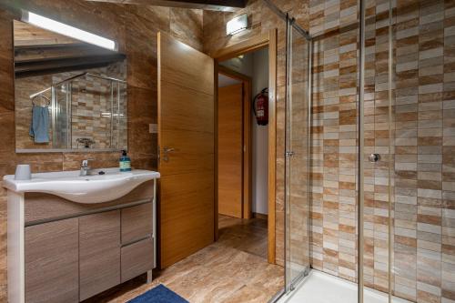 a bathroom with a sink and a shower at La Picarota in Pajares