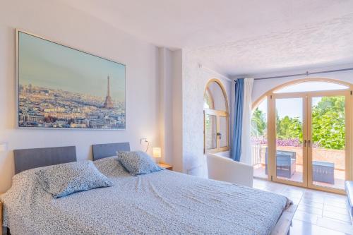 a bedroom with a bed and a large window at Simplicity luxury apartment in Altea