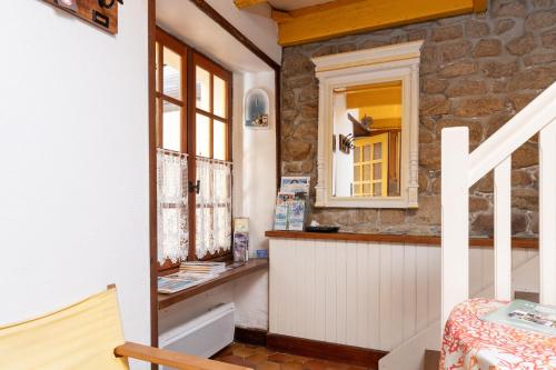 a kitchen with a counter and a window at Maison proche de la mer in Arzon