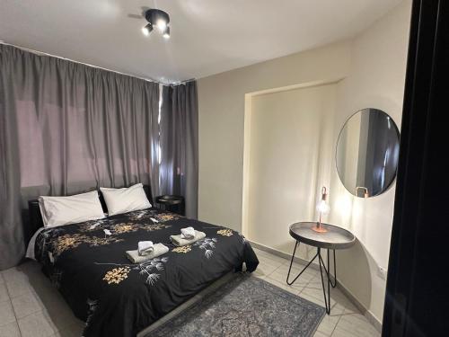 a bedroom with a bed and a table and a mirror at Serene Getaway Near Protaras in Paralimni